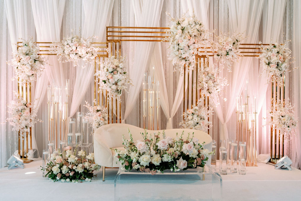 Details of a bride and groom's head table couch with luxurious decorations at Cielo At Castle Pines