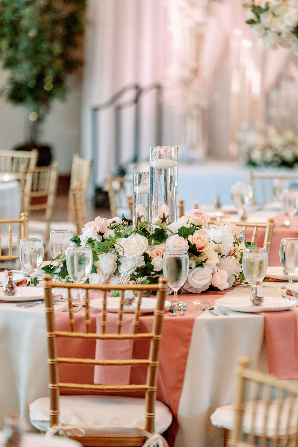 Details of a Cielo At Castle Pines wedding reception set up with pink linen and floral centerpieces