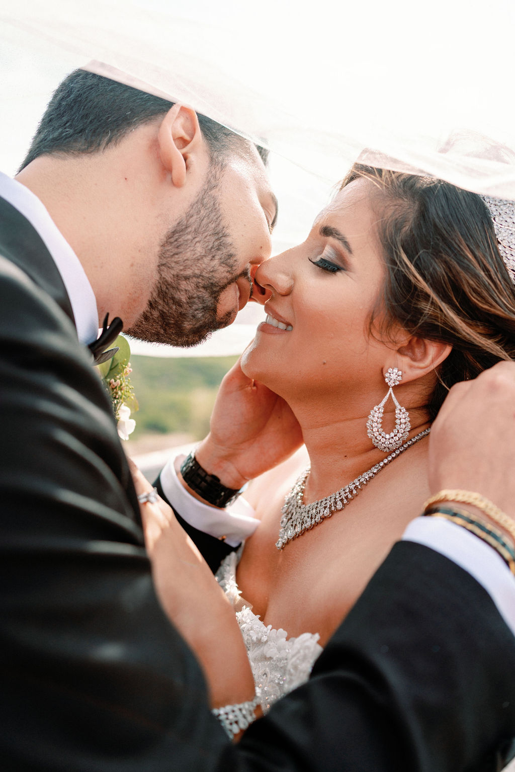 Newlyweds lean in for a happy kiss under the veil