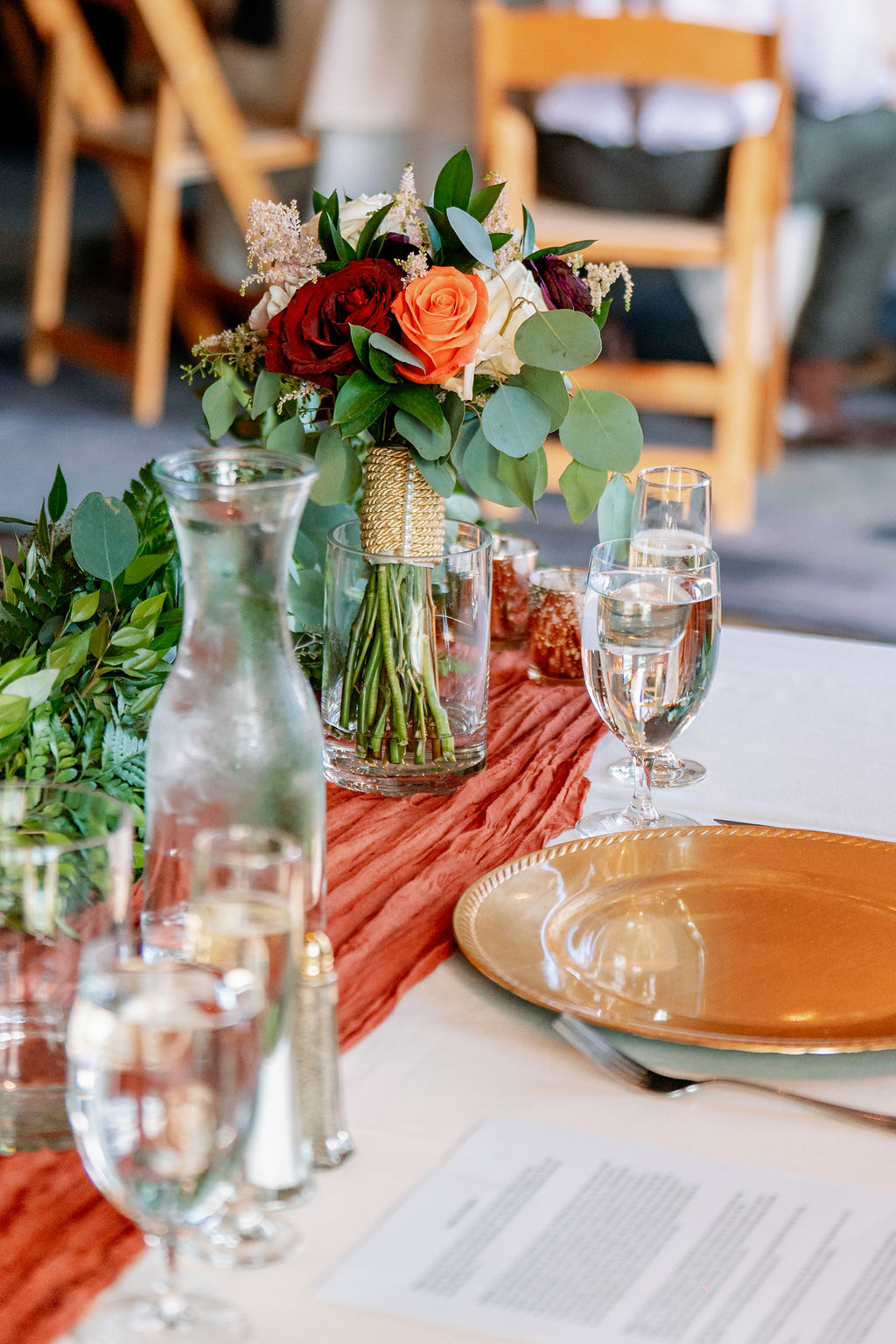 Details of a wedding reception table setting with a bouquet