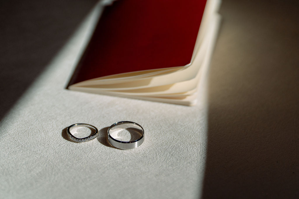 Details of rings on a table with a red notebook