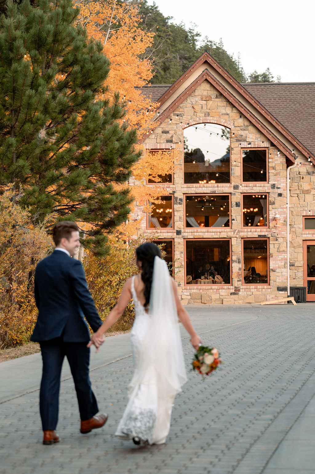 Newlyweds laugh while talking towards the Della Terra Wedding venue