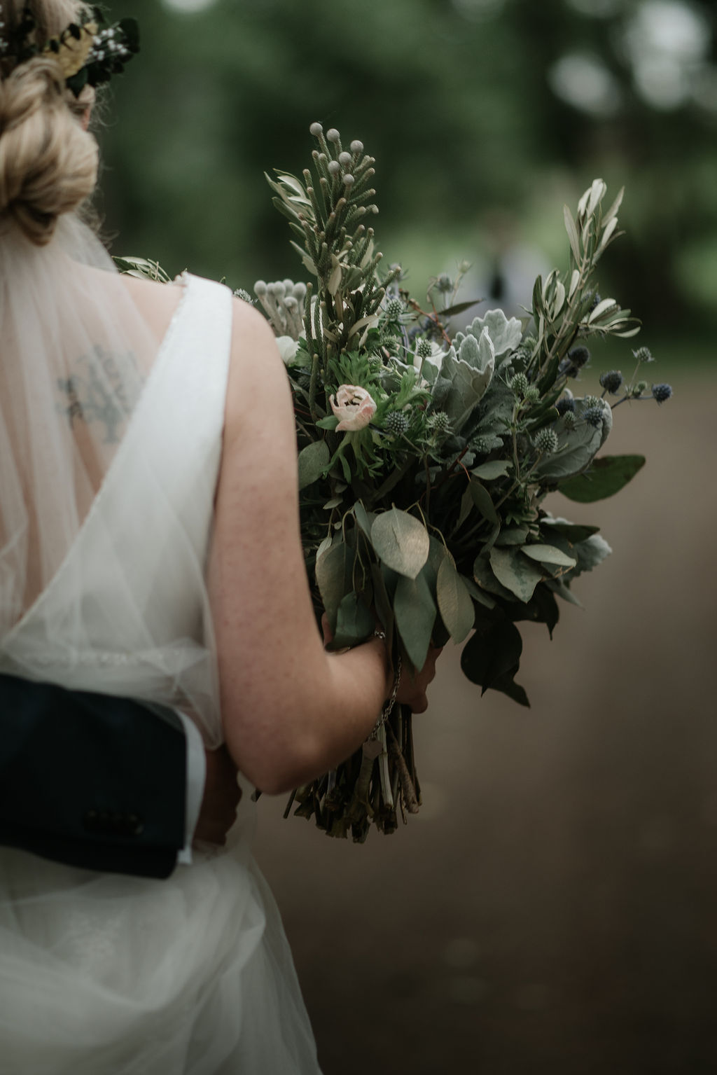Details of a bride's bouquet as she carries it while walking