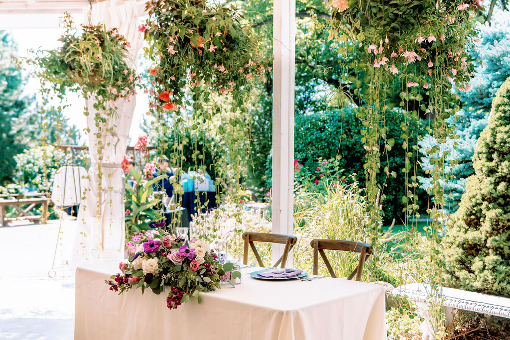A peek at the head table under lush gardens at Tapestry House By Wedgewood Weddings