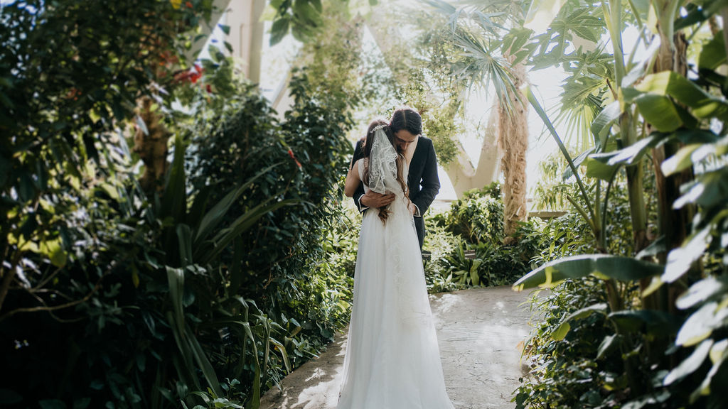 Newlyweds embrace tightly in the Botanic Gardens path at one of the stunning wedding venues near Denver